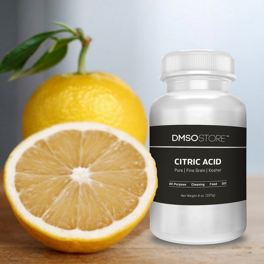 Bottle of DMSO Store Citric Acid next to a lemon on a wooden surface.