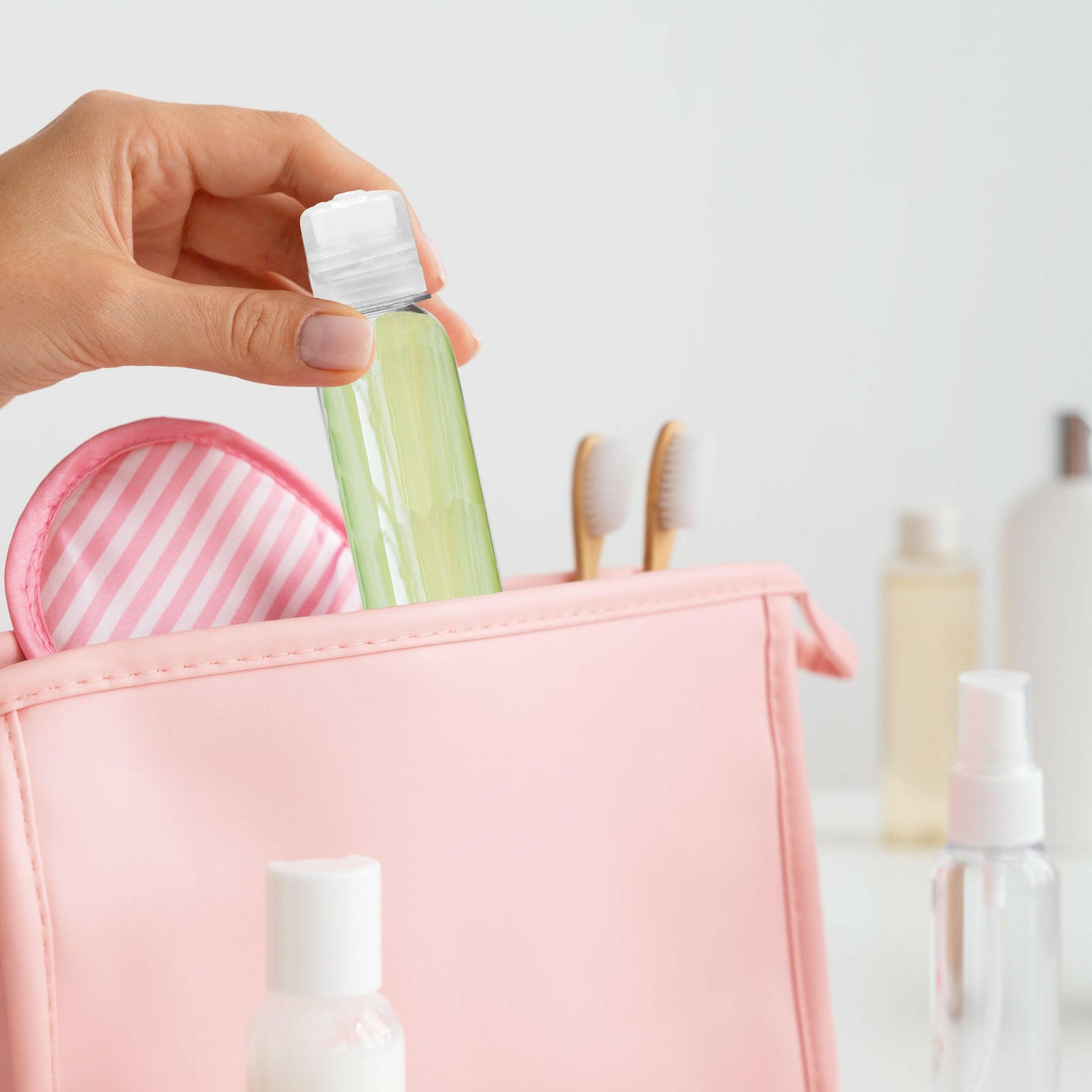 Green gel in a 4 oz Clear PET Cosmo Plastic Bottle with Clear Twist Top Cap, in a pink handbag