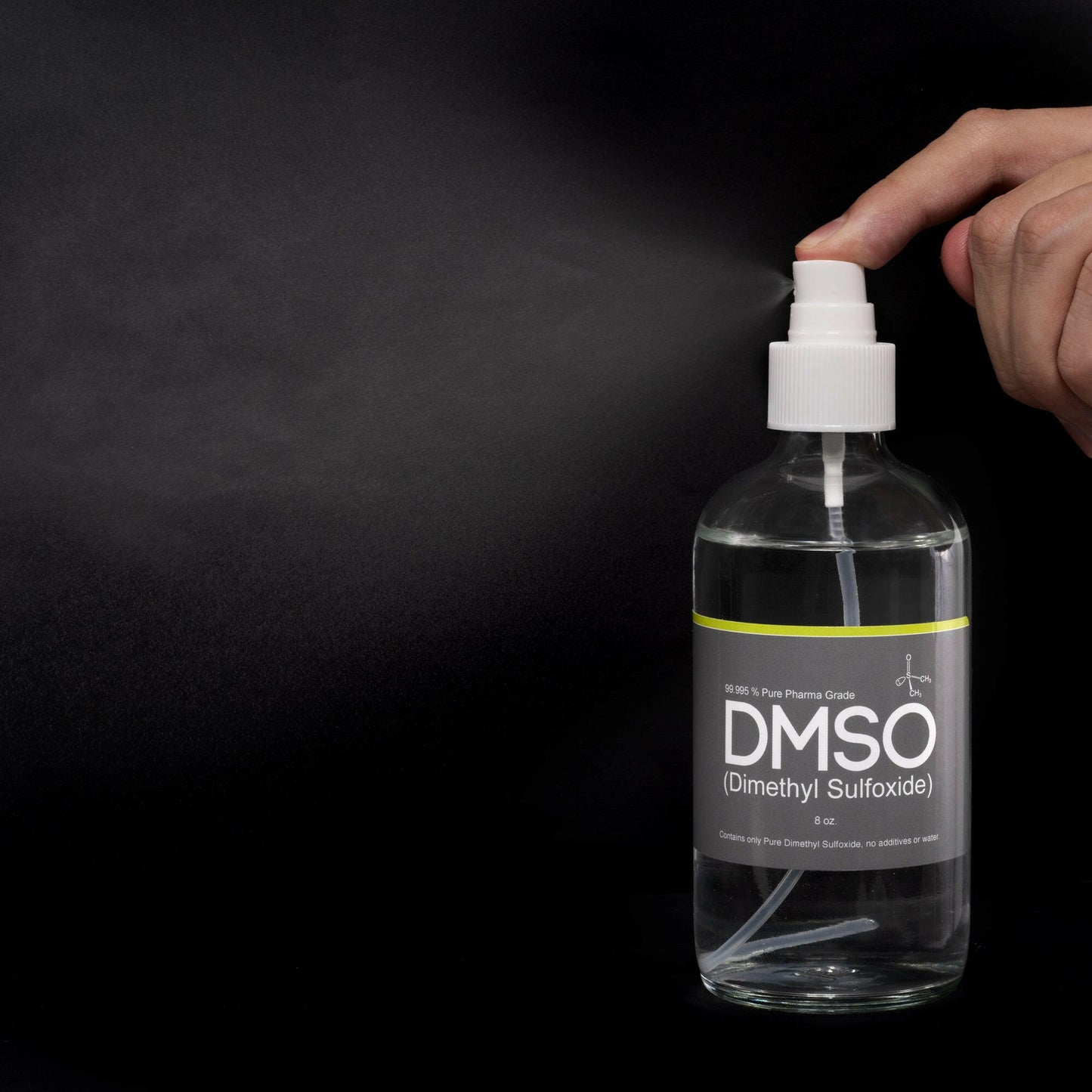 DMSO-liquid-99.995-8oz.-spray-application-horses-natural-dimethyl-sulfoxide. 8 oz glass bottles with sprayer twist on cap attached to bottle. Label reads 99.995% Pure pharma Grade DMSO (Dimethyl Sulfoxide) 8oz. There is hand in the picture with a finger pressing down on the sprayer top. A spray of DMSO is being ejected from the nozzle. This photo is used to demonstrate how to work the sprayer top.