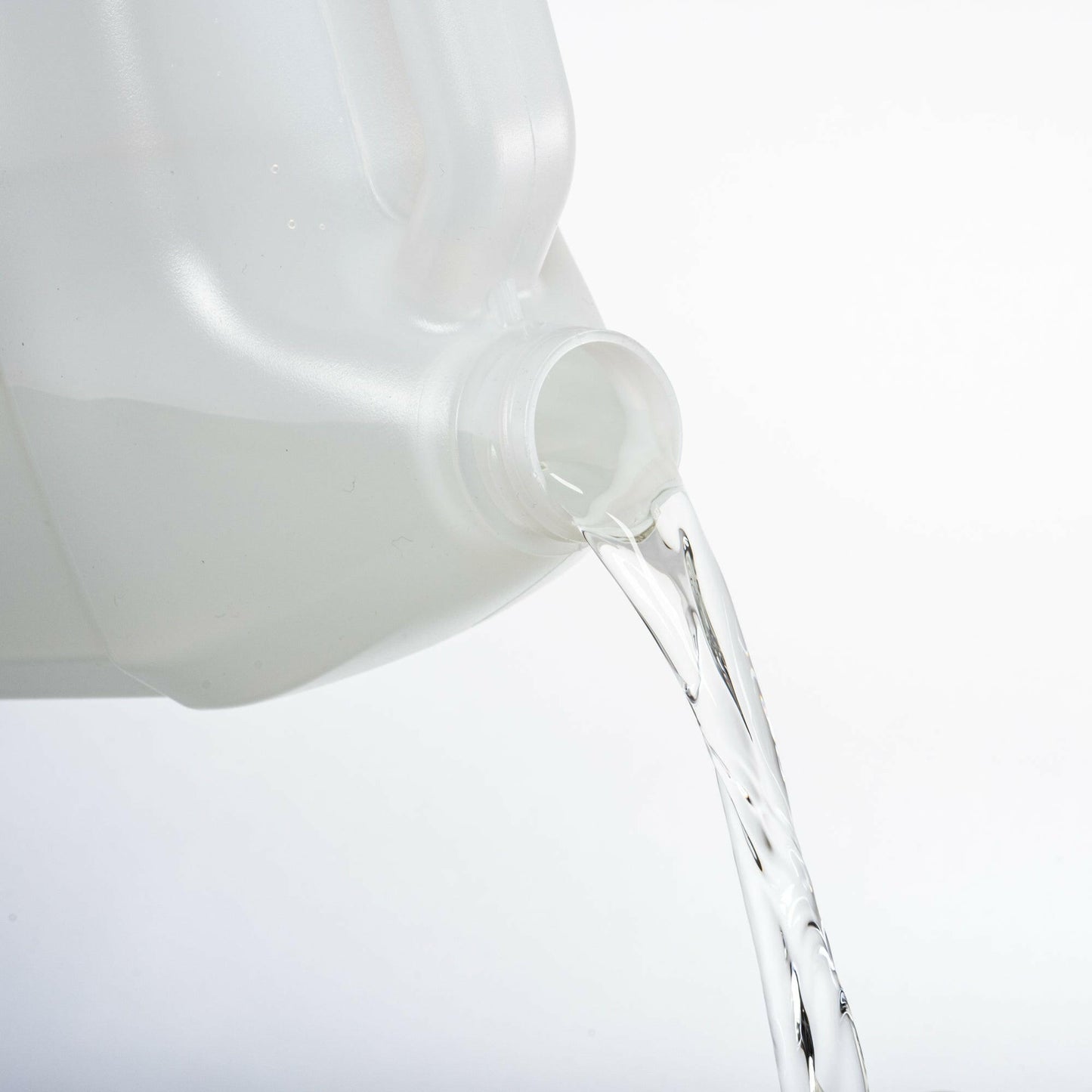 Opening of the gallon plastic jug is visible with cap and casing removed. There is liquid pouring out of the opening of the bottle.