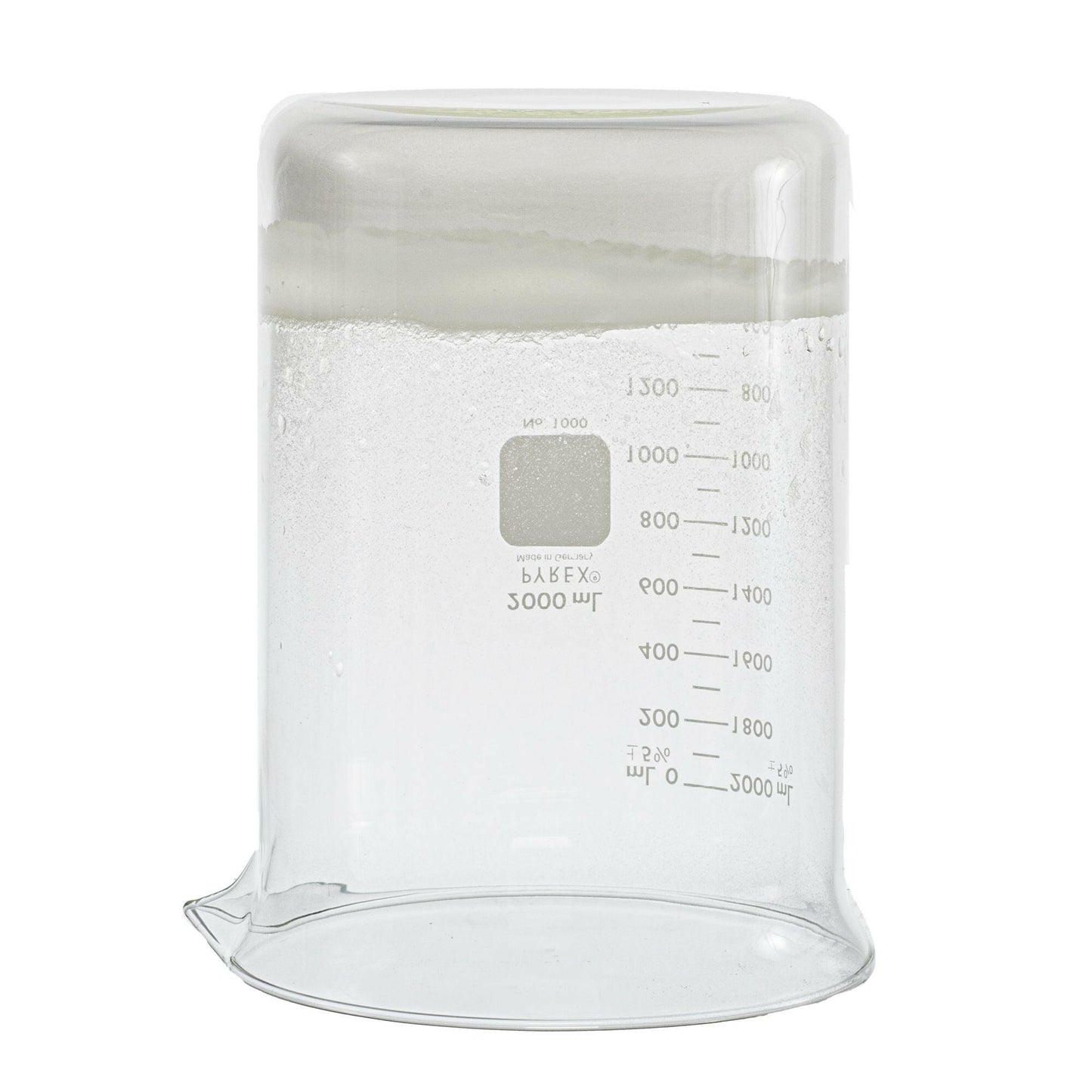 upside-down 2000 milliliter glass beaker. Beaker contains the sodium polyacrylate product after water was poured into it. The product is sticking to the bottom of beaker. Picture is used to display consistency of product after water contact.
