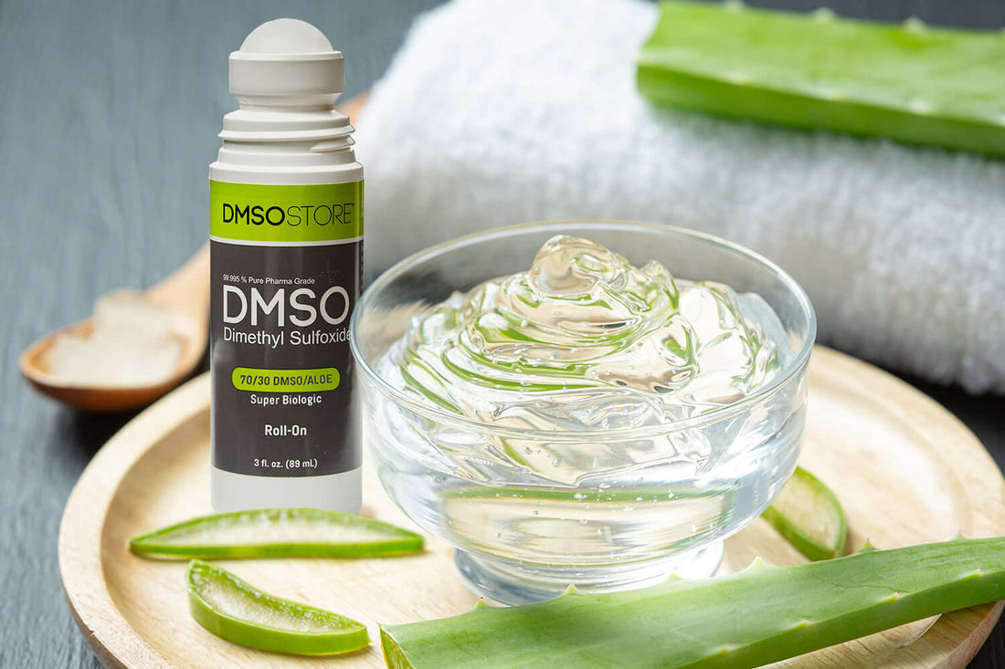 Glass bowl with aloe vera gel mixed with dimethyl slfoxiede, bottle of DMSO, sliced aloe leaves. 