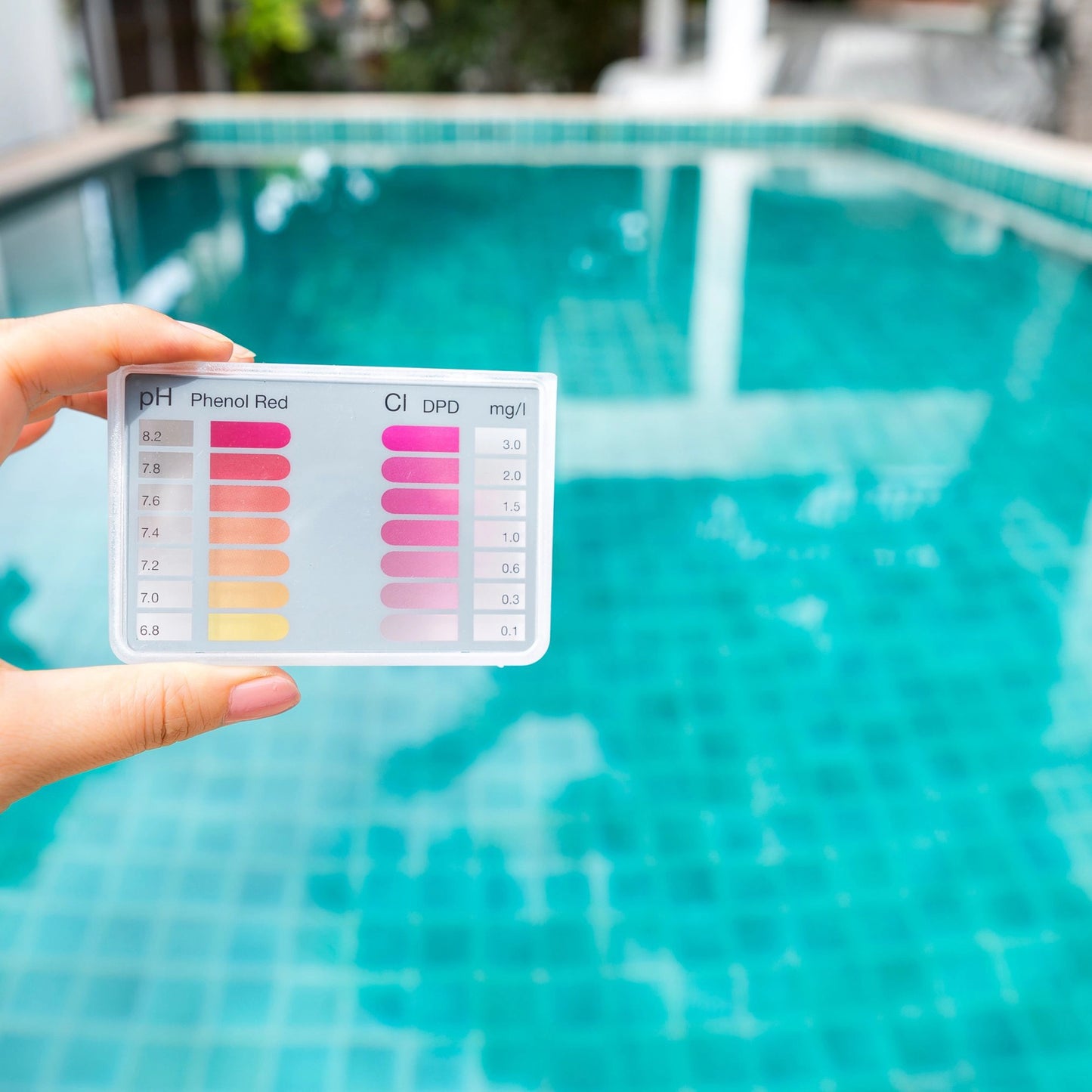 Holdng PH scale in front of swimming pool. Wondering where to buy sodium carbonate? Shop DMSO Store