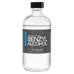 Clear glass bottle with a black plastic twist off cap. Label reads "Benzyl Alcohol non hazardous liquid" 8 oz