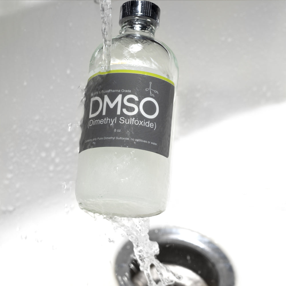 Glass 8 oz bottle of DMSO being run under water from a sink facet. This image is used to describe how to deforst a bottle of DMSO in the event that it gets frozen.
