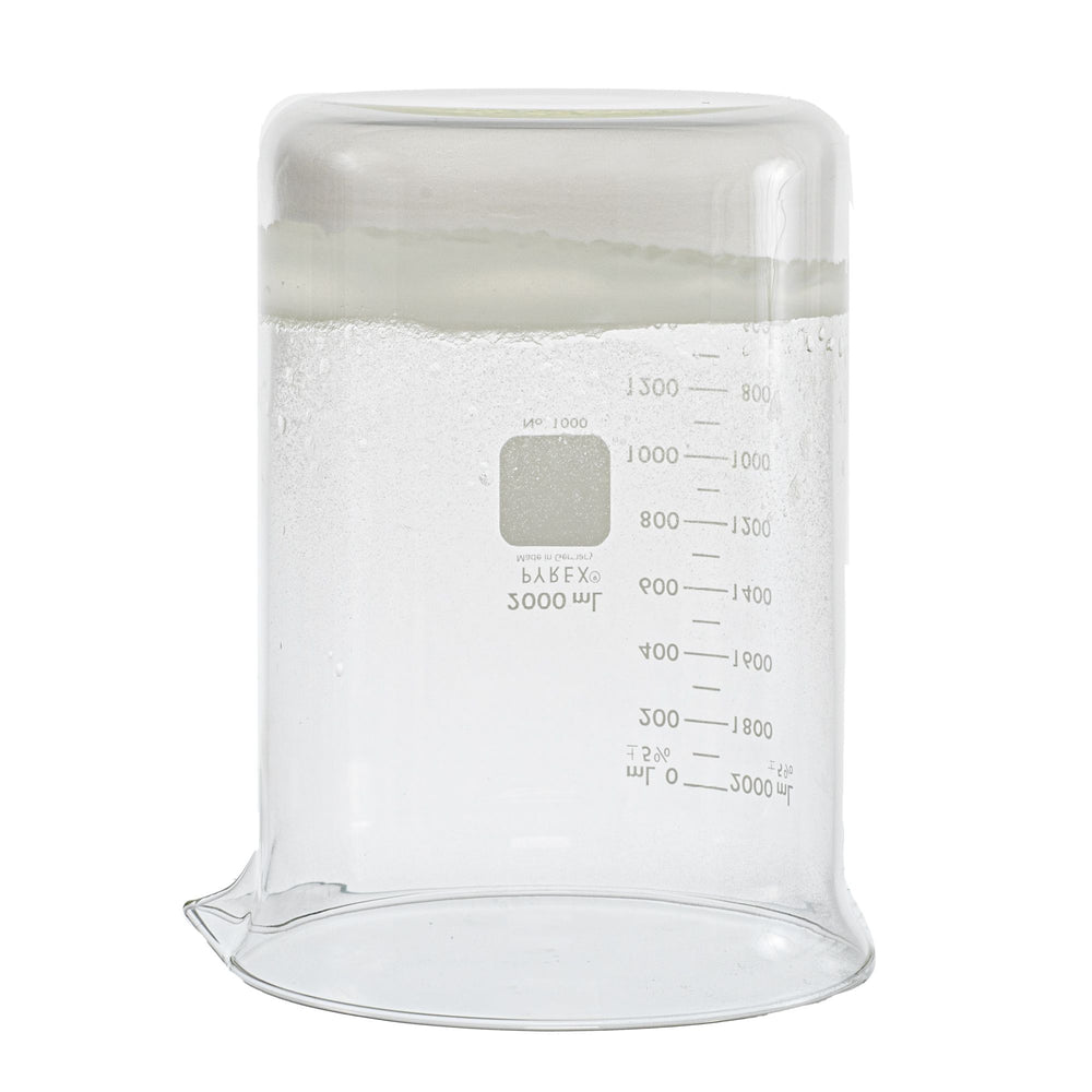 upside-down 2000 milliliter glass beaker. Beaker contains the sodium polyacrylate product after water was poured into it. The product is sticking to the bottom of beaker. Picture is used to display consistency of product after water contact. 